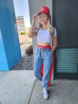 The red on denim pants
